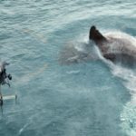 The Meg circles underneath a helicopter.