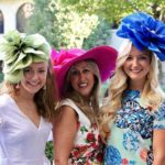 Pretty women dress up for ladie’s day at a horseracing track