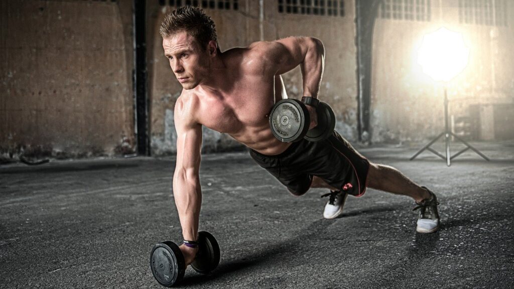 man using dumbbells to exercise